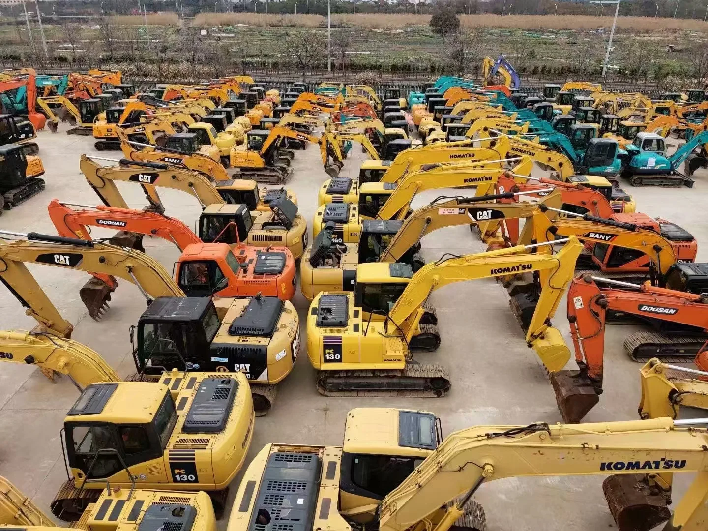 Large yard of used excavators ready for export from China