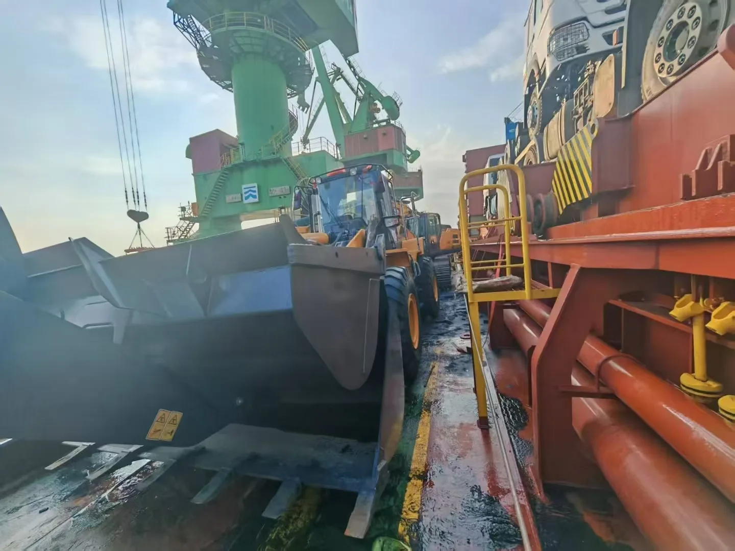 Used wheel loaders stowed on the deck of a break bulk vessel at Shanghai port